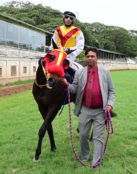 Alluring Beauty (Mohd Talib up) winner of the JAYANAGARA PLATE, being led in by trainer Rakesh on Friday races at Mysore. 